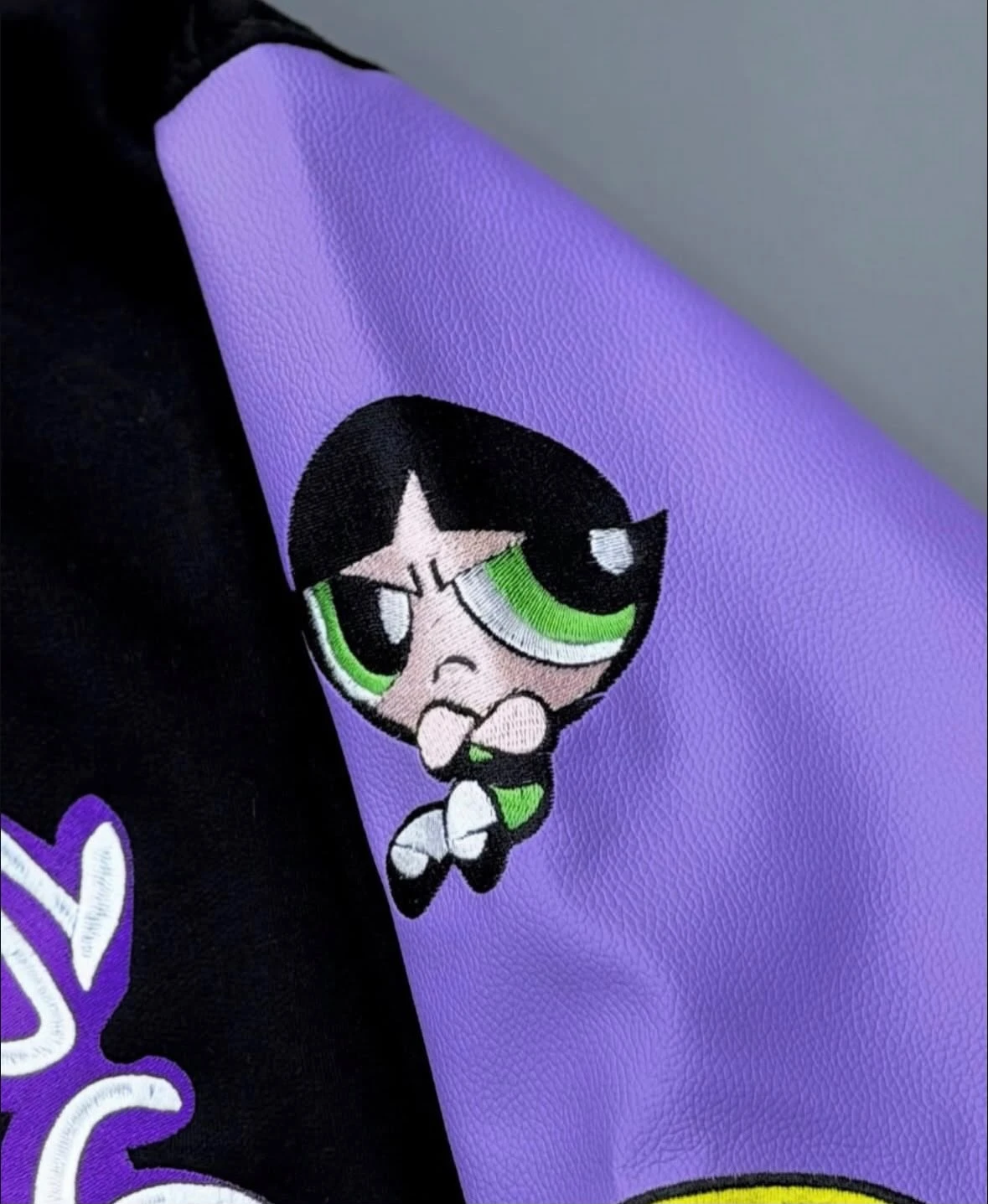 Embroidered cartoon character on a leather sleeve